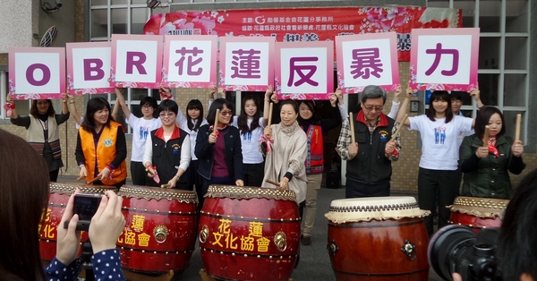 Participants of the event drumming together to oppose violence