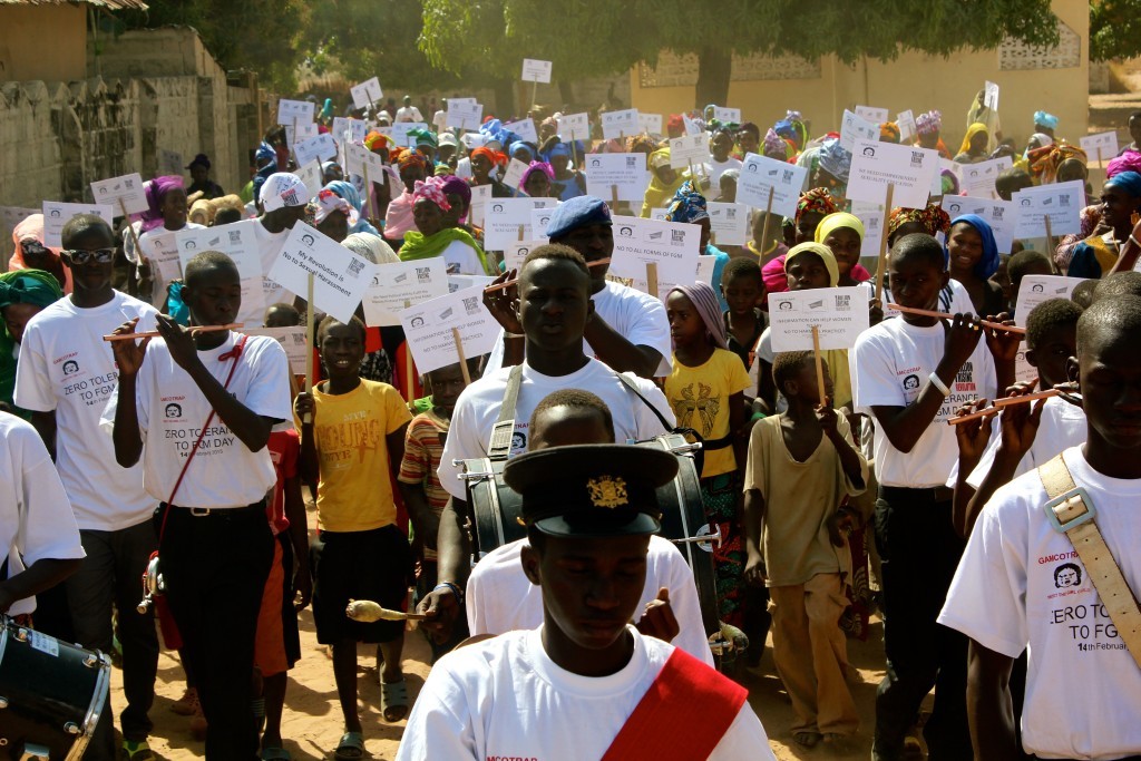 Hundreds on women, men, girls and boys marched through No Kunda, a village in Upper Badibou region of Gambia to denounce Female Genital Mutilation. An influential ex-circumciser, Fatoumatta, joined the Revolution and publicly declared to protect children has convinced 30 local circumcisers to also drop the knife. (Photo Credit: Emily Thompson)